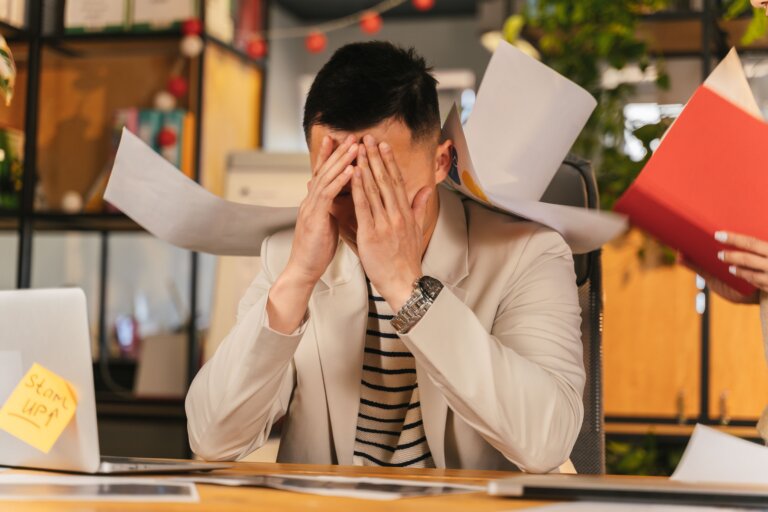 Professional experiencing stress while working at a desk