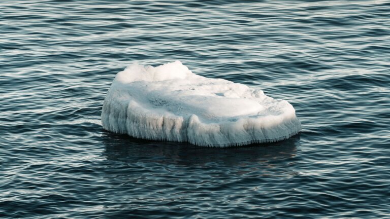 Iceberg floating in calm water, symbolizing the conscious and subconscious mind