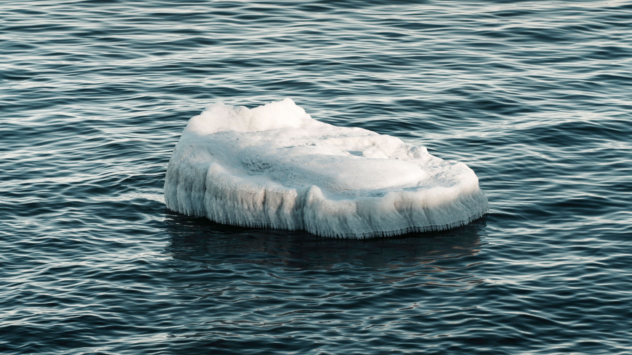 Iceberg floating in calm water, symbolizing the conscious and subconscious mind