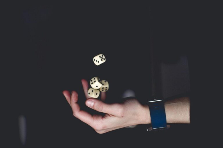 Hand holding dice symbolizing gambling addiction