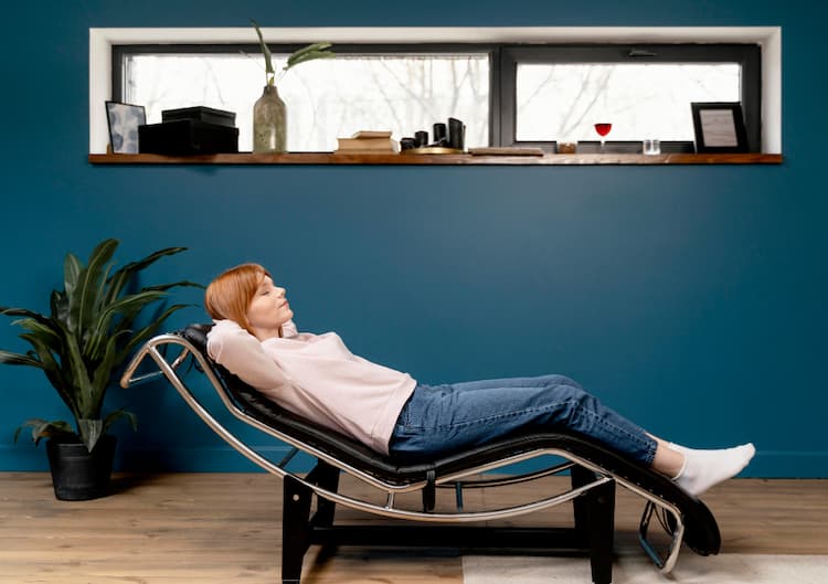 A person lying relaxed with eyes closed in a calm therapy or meditation setting, symbolizing healing, mindfulness, and inner peace