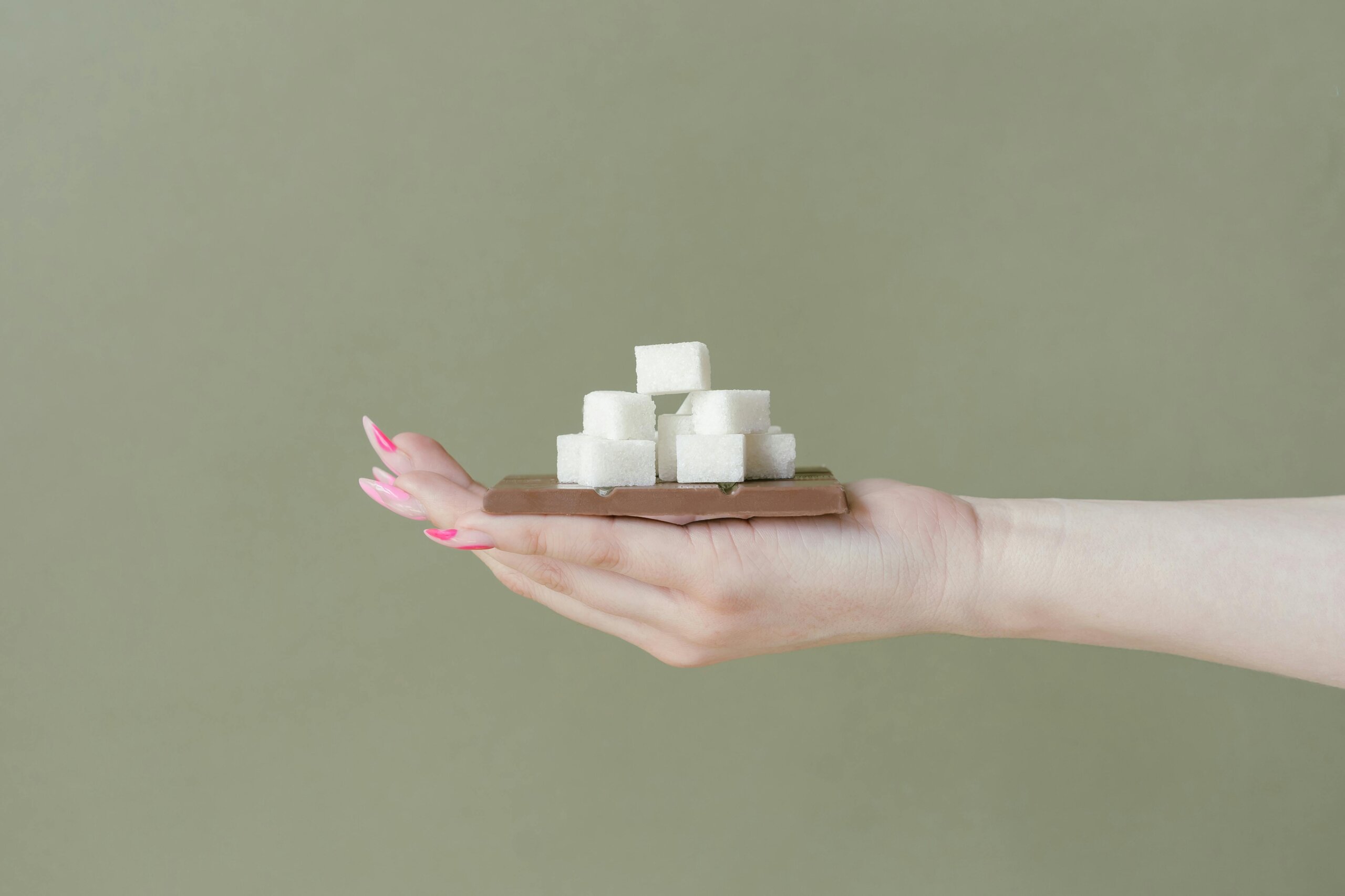 Hands holding sugar cubes representing control over sugar intake and healthy choices