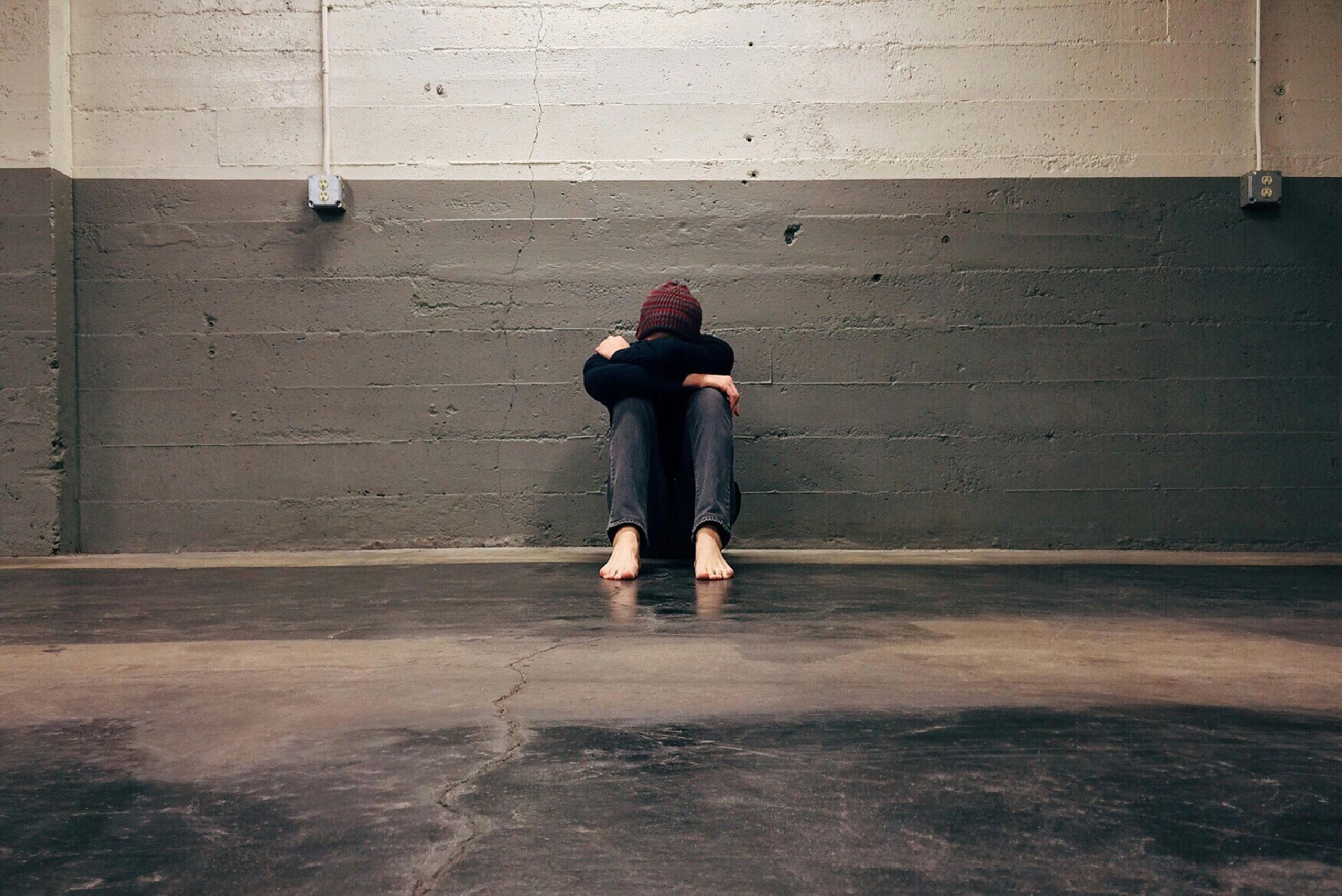 Person sitting alone showing anxiety before performing