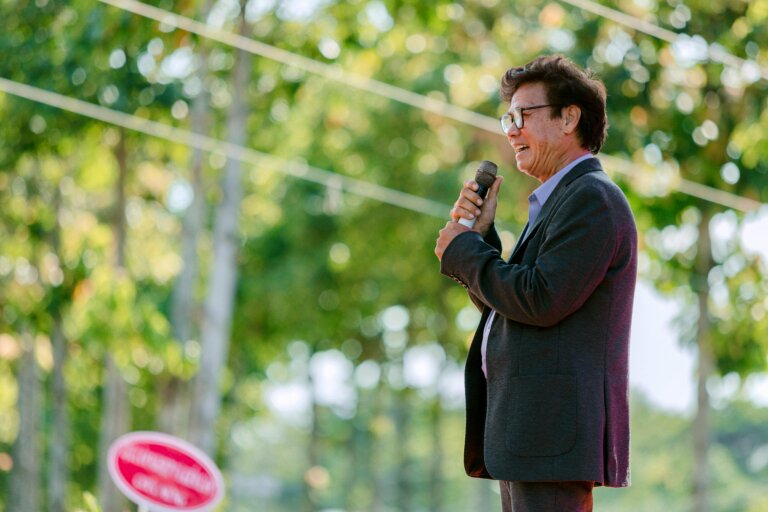 Confident speaker standing and speaking clearly in front of an audience, public speaking