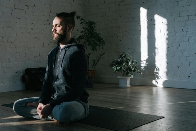 Person meditating peacefully to reduce stress and improve mental clarity