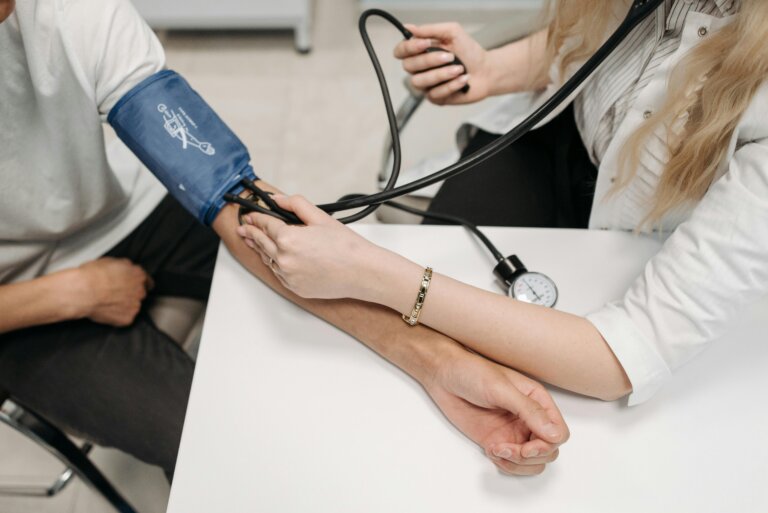 Person having high blood pressure measured by a nurse, highlighting hypertension monitoring and heart health,