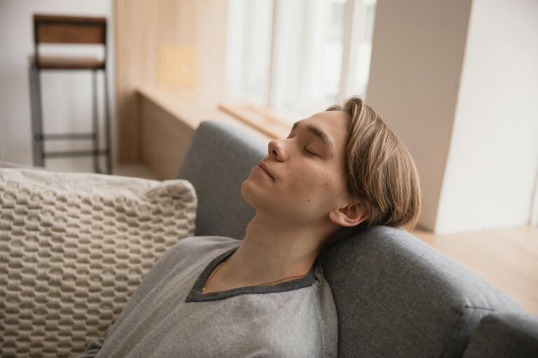 Relaxed person releasing muscle tension in a calm and peaceful setting