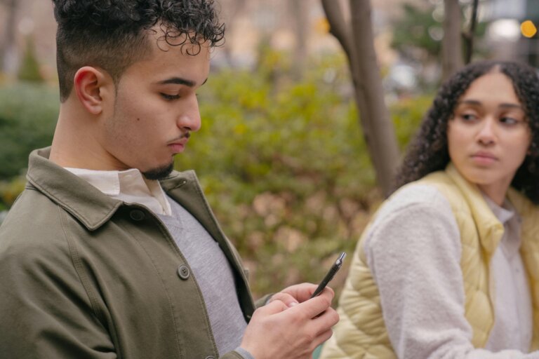 Individual or couple looking thoughtful and emotionally distant while sitting in the same space